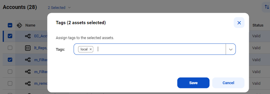 The Tags dialog box shows two assets selected and includes the Tags drop-down list. The bottom of the box contains the Save and Cancel buttons.